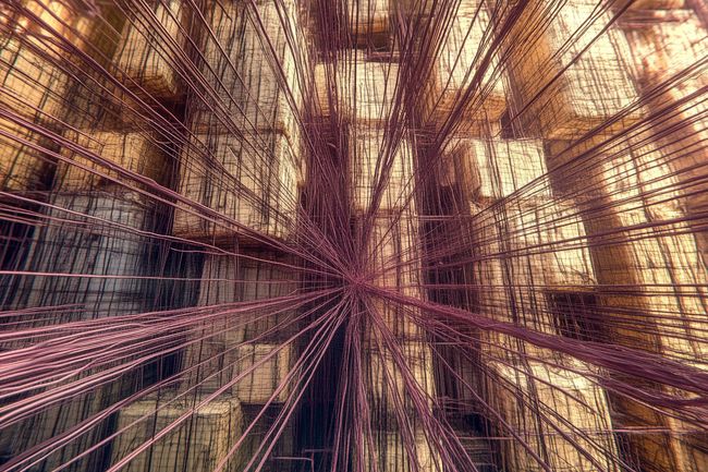 A digital symphony of interconnected nodes, glowing with pink and purple hues, set against a dark, textured backdrop with a nostalgic film grain.