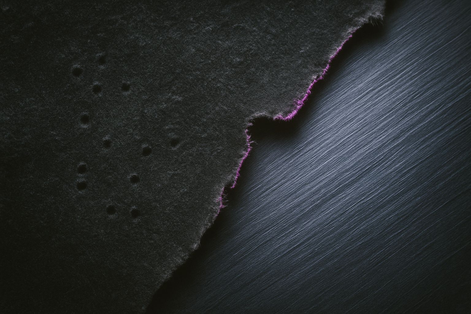 Brushed metal and velvet tear apart to expose purple glints.